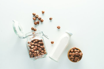 Naklejka premium vegan milk in glass jar on white background