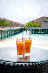 Iced tea against tropical Overwater Bungalow Resort, Maldives.