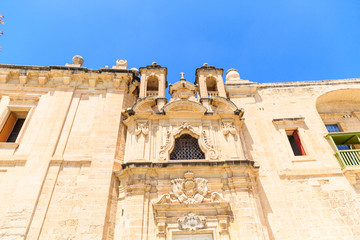 Naklejka premium beautiful baroque building with bright doors and shutters built with sandstone