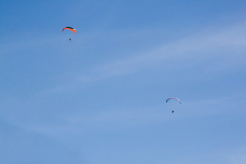 two parachutes flying in the sky very high