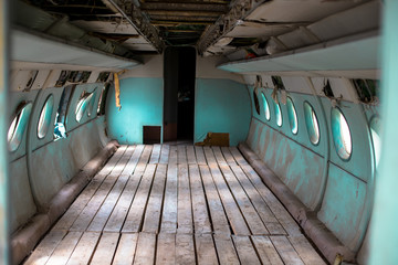 Inside a very old plane. Passenger cabin of a small old plane.