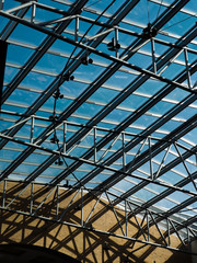 An abstract metal structure under the roof of the mall