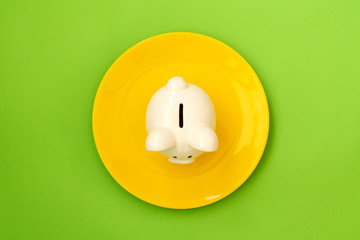 Yellow ceramic plate with piggy bank
