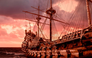 Re-production of a galleon in public site in Genova, Italy, stormy sky  - obrazy, fototapety, plakaty