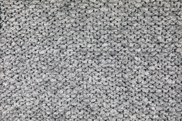 Loose Knitwear Fabric Texture with wool fibers. Repeating Machine Knitting Texture of warm Sweater. Grey Knitted Background.