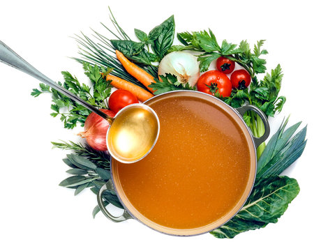 Pan of broth and vegetables isolated
