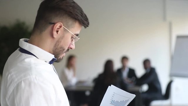 Anxious speaker read papers afraid of public speaking at presentation