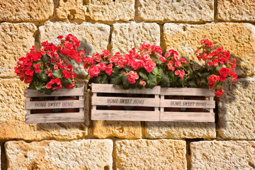Wooden flowers boxes against an old brick wall - Home sweet home