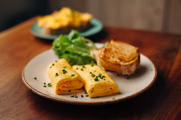 French rolled omelette with chives on a plate