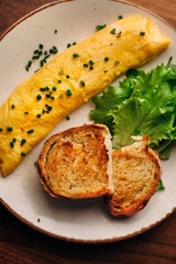 French rolled omelette with chives on a plate