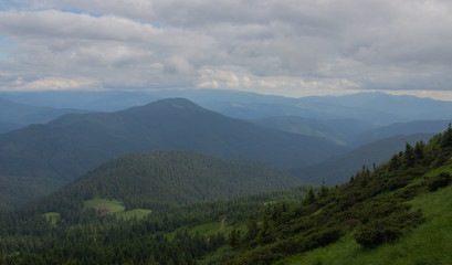 Fototapeta premium Hiking with a tent through Petros to Hoverla, Lake Nesamovite, Mount Pop Ivan Observatory.