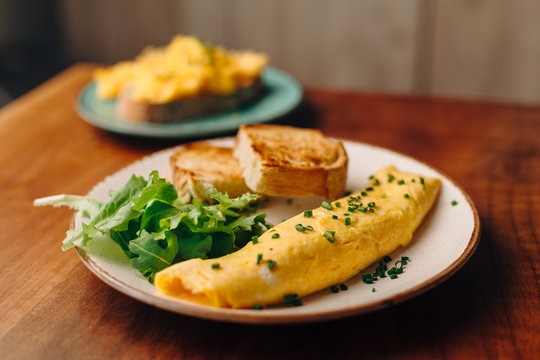 French Rolled Omelette With Chives On A Plate