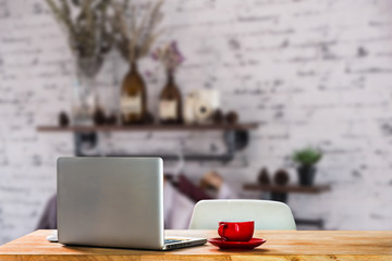 workspace with desktop computer, office supplies, houseplant and coffee cup at office.
