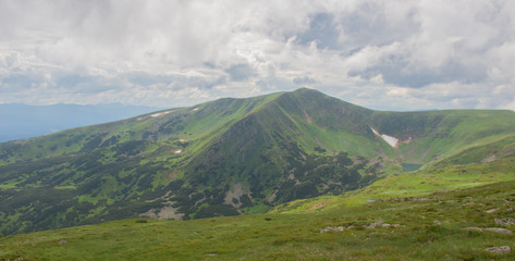 Fototapeta premium Hiking with a tent through Petros to Hoverla, Lake Nesamovite, Mount Pop Ivan Observatory.