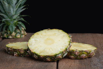 pieapple on old wooden with black background