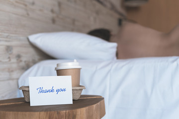 A paper cup of coffee and sticker with phrase 