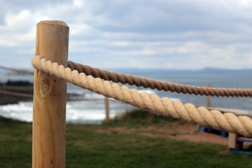 Obraz premium Roped off footpath along a cliff walk on Scotlands East coast. 