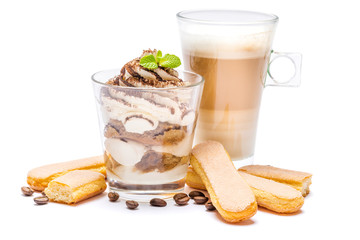 Classic tiramisu dessert in a glass, savoiardi cookies and cup of coffee isolated on a white background with clipping path