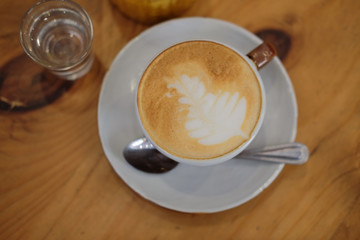 hot cappuccino coffee latte on wood table.