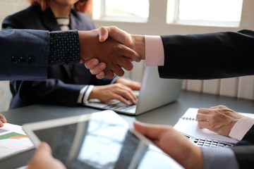 Business people shaking hands after meeting. colleagues handshaking. teamwork partnership concept.