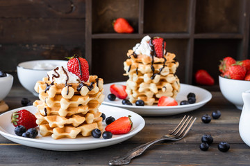 Waffles with berries and whipped cream