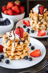 Waffles with berries and whipped cream