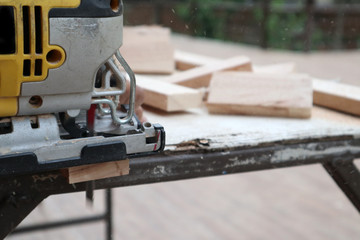 carpenter cutting wood with saw