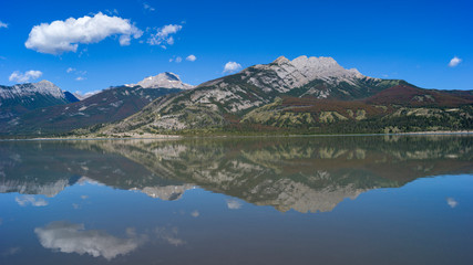 Fototapeta na wymiar Reflection of mountains in Jasper Lake, Yellowhead Highway, Jasper National Park, Jasper, Alberta, Canada