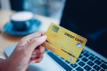 woman hard using credit card with laptop comouter