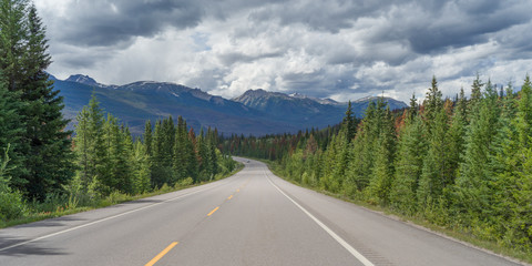Highway with mountains in the background, Icefields Parkway, Jasper, Alberta, Canada