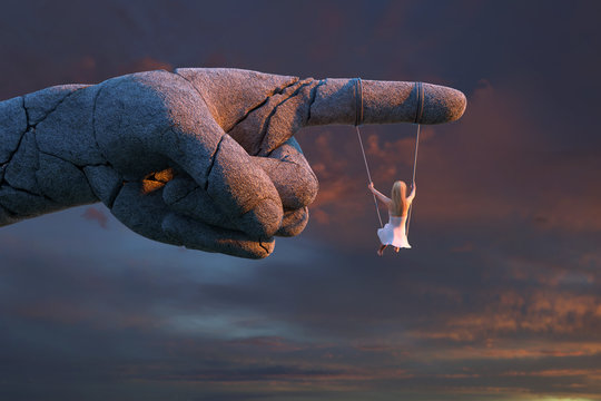 girl riding on a monument to the overthrown dictator