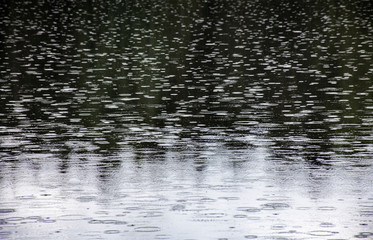 Fototapeta na wymiar Rainy day on water surface