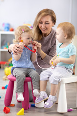 Children learning with teacher are doctor and patient.