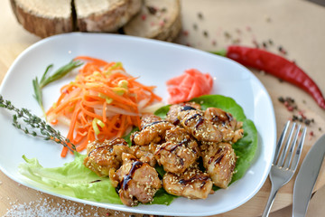 teriyaki chicken with vegetable salad on a plate