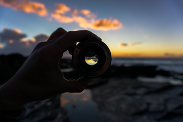 man looking through lens