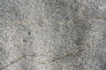 Closeup macro view of rough stone surface gray color. Detailed nature background or pattern texture taken in natural environment. Weathered many years, inimitable and unique effect to textured design