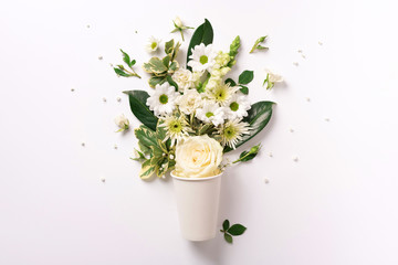 Creative layout made of paper cup with white flowers. Flat lay, top view. Banner with copy space. Valentines day, Woman day concept. Spring or summer banner with copy space
