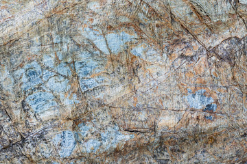 Cracked stone surface brown, gray, blue color. Nature background pattern texture