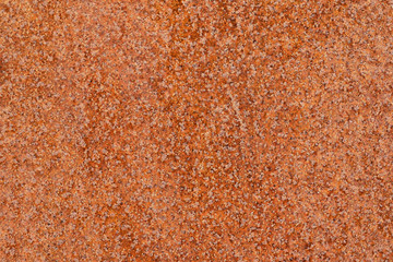 Close up macro view of flecked old rusty metal surface yellow-orange color. Detailed pattern texture or background taken in natural environment. Weathered over years, unique effect to textured design.