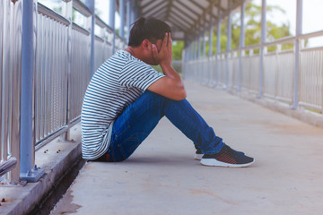 Men sitting on the overpass