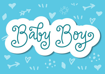 Modern calligraphy lettering of Baby Boy in blue with white outline in paper cut style on blue background