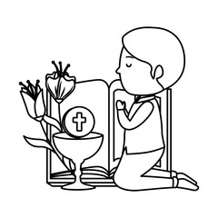little boy kneeling with book and chalice first communion