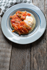 Mexican food: Fried egg rancheros with sauce and corn tortilla