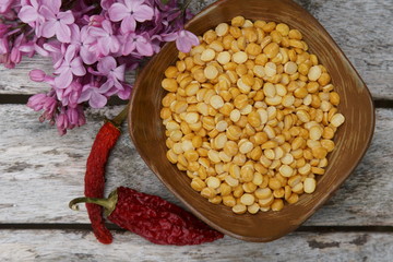 A bowl of uncooked Chana daal or yellow split peas.