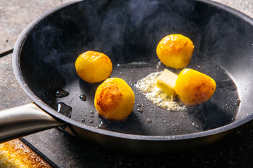 potatoes fried in butter in a cast iron skillet