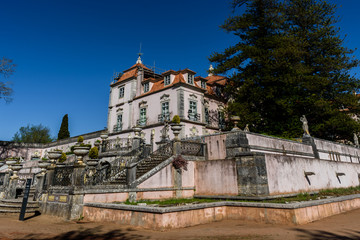 Fototapeta na wymiar Oeiras - Lisbon, Portugal - March 10, 2019 - Perspective of the Marquis of Pombal Palace from the garden, sighting the staircases and decorative statues