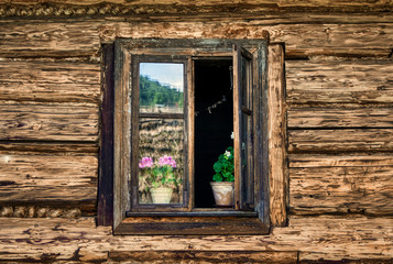 Fototapeta na wymiar window on old log wall