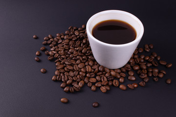 White tableware full of espresso stands in coffee beans
