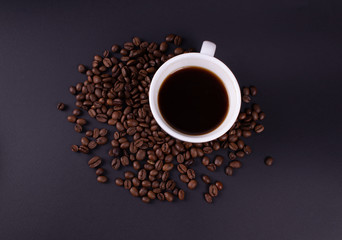 A cup of fresh brewed coffee with coffee beans photo from above