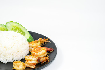 Fried rice with shrimp basil topped with rice on a black plate